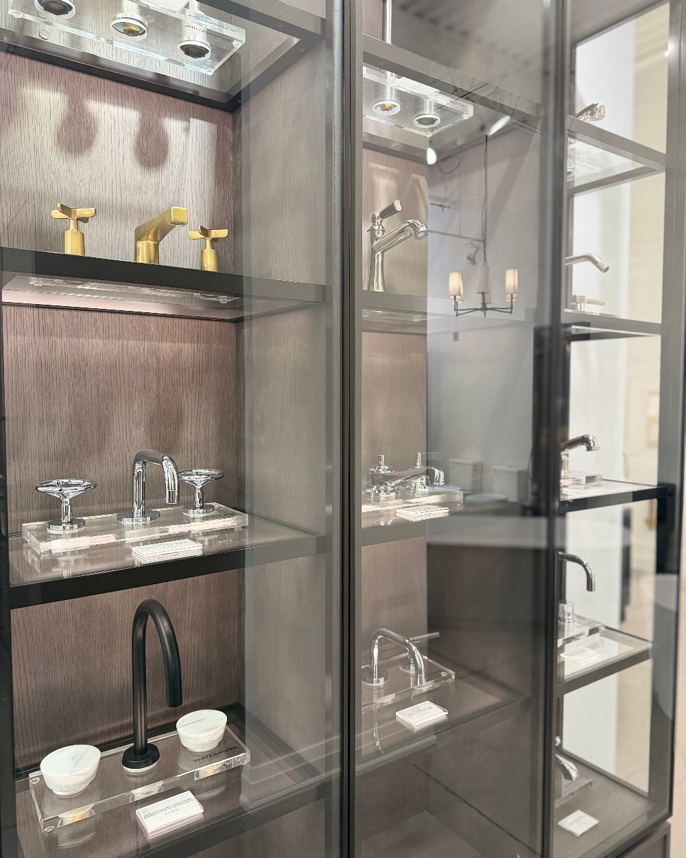 Display case with various bathroom fixtures and fittings.