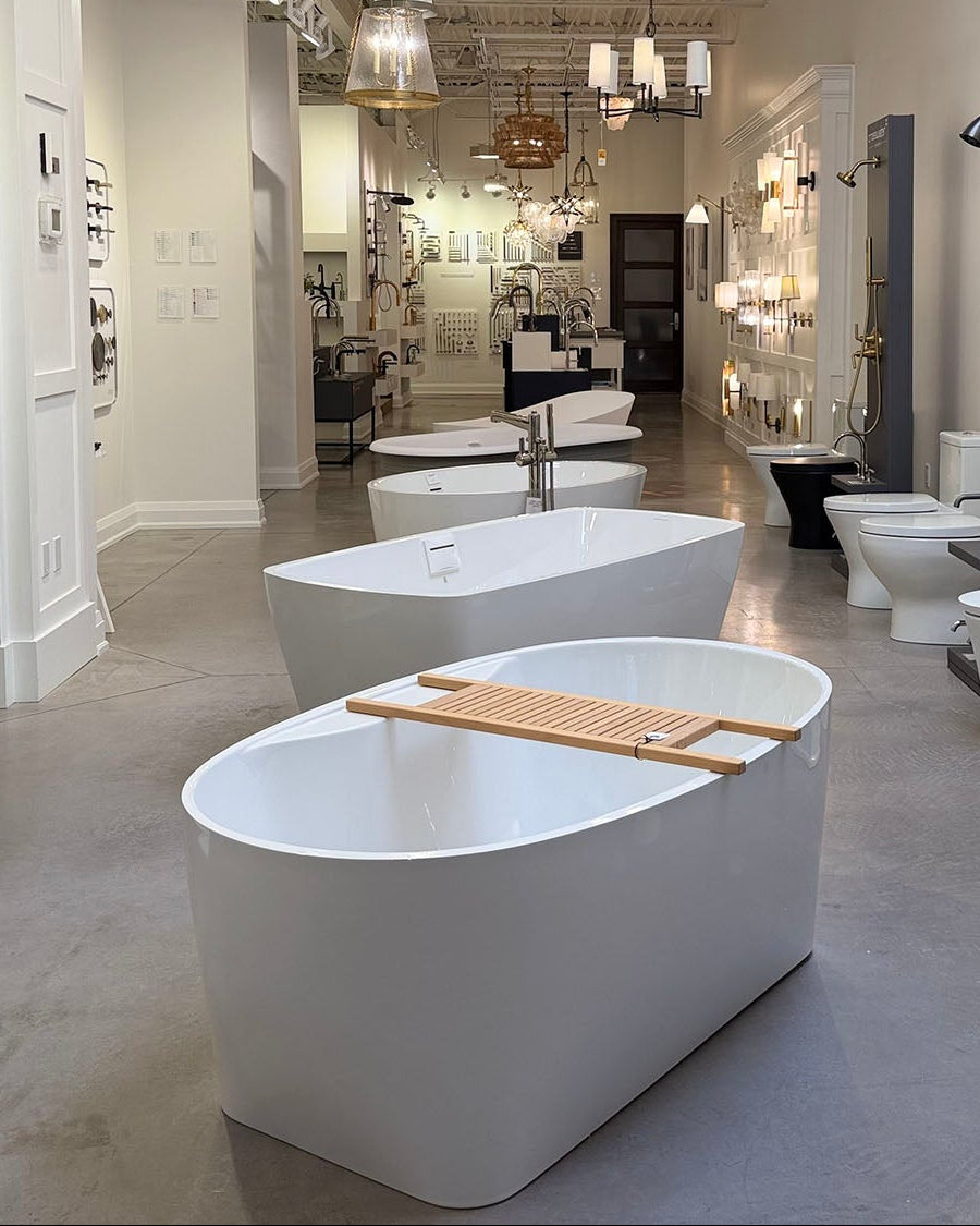 Modern freestanding bathtub with a wooden tray in a showroom setting