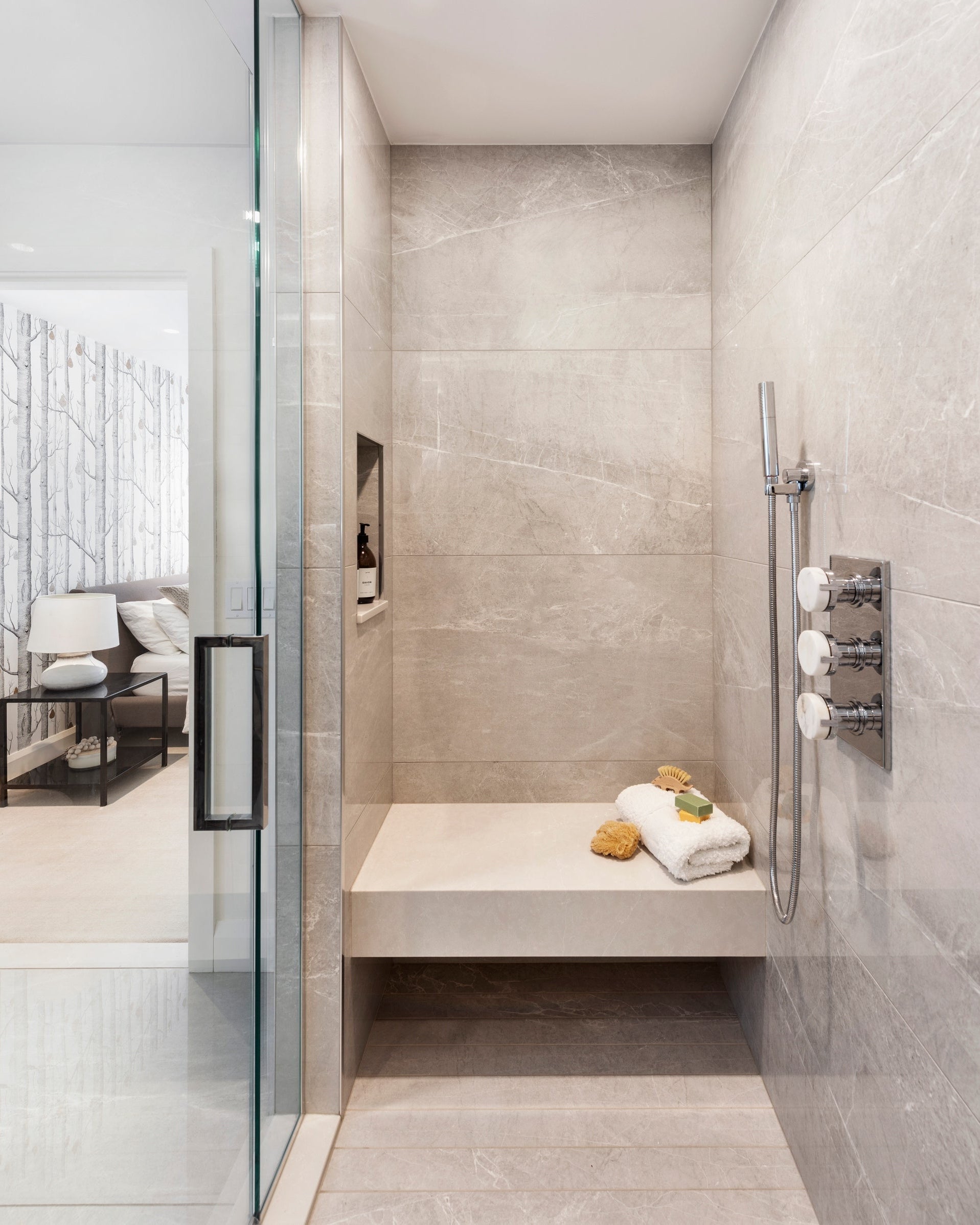 Modern bathroom with tiled walls and a shower area.